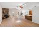Bright living room with wood-look flooring, fireplace, skylight, and a bar area for entertaining at 1368 Noell Blvd, Palm Harbor, FL 34683