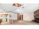 Open-concept living area with a brick fireplace, skylight, and a breakfast bar connecting to the kitchen at 1368 Noell Blvd, Palm Harbor, FL 34683