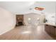 Spacious living room with a brick fireplace, wood-look flooring, skylight, and ample natural light at 1368 Noell Blvd, Palm Harbor, FL 34683