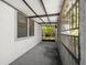 A covered patio shows a view of the fenced yard with foliage at 1368 Noell Blvd, Palm Harbor, FL 34683