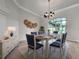 Elegant dining room showcasing a decorative chandelier, stylish furniture, and neutral colors at 1403 Crooked Stick Dr, Valrico, FL 33596