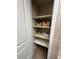 Bathroom closet featuring shelving and baskets for organized storage and convenience at 15 Pinewood E Ter, Palm Harbor, FL 34683