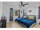 Cozy bedroom featuring two twin beds, natural light from multiple windows, and hardwood flooring at 164 Nw Lincoln N Cir, St Petersburg, FL 33702