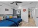 Comfortable bedroom with two beds, ceiling fan, mirrored closet, and hardwood floors at 164 Nw Lincoln N Cir, St Petersburg, FL 33702