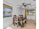 Bright dining area with wooden table set, ceiling fan, and two windows for natural light at 164 Nw Lincoln N Cir, St Petersburg, FL 33702