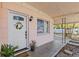 Close up on front porch, white door with decorative wreath at 164 Nw Lincoln N Cir, St Petersburg, FL 33702
