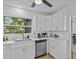 Bright and efficient kitchen with stainless steel appliances, generous counter space, and custom cabinetry at 164 Nw Lincoln N Cir, St Petersburg, FL 33702