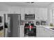 Updated kitchen with stainless appliances and white cabinetry at 164 Nw Lincoln N Cir, St Petersburg, FL 33702