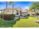 Beautiful front exterior of a single Gathering home with well-maintained landscaping and a side entry three car garage at 16901 Ivy Lake Dr, Odessa, FL 33556