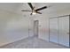 Bright bedroom with neutral carpet, featuring a closet and an open doorway leading to more of the home at 1832 Bough Ave # 3, Clearwater, FL 33760