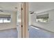 Bright bedroom featuring neutral carpet, a modern ceiling fan and large window for ample natural light at 1832 Bough Ave # 3, Clearwater, FL 33760
