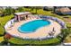 An aerial shot highlights the community pool, with seating and lounging areas, for outdoor recreation at 1832 Bough Ave # 3, Clearwater, FL 33760