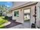 The unit's entrance boasts a modern glass door, complemented by an exterior bench and lush landscaping at 1832 Bough Ave # 3, Clearwater, FL 33760