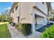 Exterior view of a multi-story home with a two-car garage, well-kept landscaping, and ample curb appeal at 1832 Bough Ave # 3, Clearwater, FL 33760