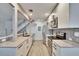 Well-lit kitchen with stainless steel appliances, granite countertops, and modern tile backsplash at 1832 Bough Ave # 3, Clearwater, FL 33760
