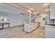 A spacious living room featuring an open kitchen concept and modern wood-look flooring at 1832 Bough Ave # 3, Clearwater, FL 33760