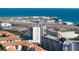 Stunning aerial view showing the real estate with the ocean, airport and city skyline in the background on a bright sunny day at 199 Dali Blvd # 704, St Petersburg, FL 33701