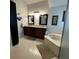 Bathroom with garden tub, double sink vanity with dark cabinets and tile floor at 2021 E Del Webb Blvd, Sun City Center, FL 33573