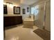 Bathroom featuring tile floors, tub, a glass-enclosed shower and vanity with double sinks at 2021 E Del Webb Blvd, Sun City Center, FL 33573