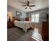 Cozy bedroom boasts natural light, ceiling fan, and wood floors at 2021 E Del Webb Blvd, Sun City Center, FL 33573