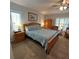 Bright bedroom with a large window and classic furnishings and ceiling fan at 2021 E Del Webb Blvd, Sun City Center, FL 33573