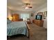 Spacious bedroom featuring a ceiling fan, neutral paint, and shuttered windows at 2021 E Del Webb Blvd, Sun City Center, FL 33573