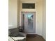 Inviting covered entryway with seating area and decorative accent window above the door at 2021 E Del Webb Blvd, Sun City Center, FL 33573
