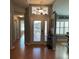 Bright foyer with a decorative transom window, wood flooring, and view of the living area at 2021 E Del Webb Blvd, Sun City Center, FL 33573