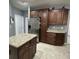 Open kitchen with granite counters, stainless steel refrigerator, and hardwood cabinets at 2021 E Del Webb Blvd, Sun City Center, FL 33573