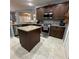 View of the kitchen with center island, stainless steel appliances, and hardwood cabinets at 2021 E Del Webb Blvd, Sun City Center, FL 33573