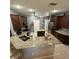 Spacious kitchen featuring granite counters, dark cabinets, and stainless steel appliances at 2021 E Del Webb Blvd, Sun City Center, FL 33573