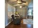Comfortable living room area featuring ceiling fans and plantation shutters at 2021 E Del Webb Blvd, Sun City Center, FL 33573
