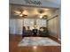 Cozy living area with comfortable seating, neutral colors, and attractive wood laminate flooring at 2021 E Del Webb Blvd, Sun City Center, FL 33573