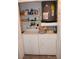 Laundry room with washer, dryer, shelving and hot water tank at 210 Corkwood Ln, Oldsmar, FL 34677