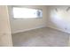 Bright bedroom with large window, tile floors, and neutral paint at 2170 Americus N Blvd # 22, Clearwater, FL 33763