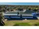 Aerial view of a clubhouse featuring an outdoor patio and surrounding greenery on a golf course at 23523 Gracewood Cir, Land O Lakes, FL 34639