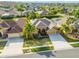Beautiful aerial view of a well-maintained property with mature landscaping and a three-car garage at 23523 Gracewood Cir, Land O Lakes, FL 34639