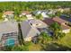 Beautiful aerial view of a home with a screened-in pool and well-manicured landscaping at 23523 Gracewood Cir, Land O Lakes, FL 34639