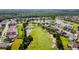Community aerial view of a golf course surrounded by well-maintained homes and lush greenery at 23523 Gracewood Cir, Land O Lakes, FL 34639
