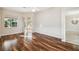 Bright bedroom featuring wood floors, a ceiling fan, and a slider to the pool area, offering a relaxing retreat at 23523 Gracewood Cir, Land O Lakes, FL 34639