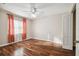 Bedroom featuring wood floors, orange curtains, and a ceiling fan at 23523 Gracewood Cir, Land O Lakes, FL 34639