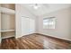 Cozy bedroom with built-in desk and closet space, wood flooring and a window for natural light at 23523 Gracewood Cir, Land O Lakes, FL 34639