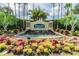 Welcoming entrance to Plantation Palms Golf Club with lush landscaping and a beautiful water feature at 23523 Gracewood Cir, Land O Lakes, FL 34639