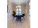 Well-lit dining room showcases a stylish chandelier, large window, and modern dining set at 23523 Gracewood Cir, Land O Lakes, FL 34639