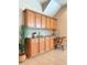 Dry bar with light wood cabinets, granite counters, tile backsplash, and a desk area at 23523 Gracewood Cir, Land O Lakes, FL 34639