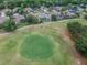 Aerial view of a community golf course featuring lush green, sand traps, and well-maintained homes at 23523 Gracewood Cir, Land O Lakes, FL 34639