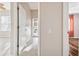 Bright hallway featuring neutral walls and tile flooring leading to multiple rooms and exterior access at 23523 Gracewood Cir, Land O Lakes, FL 34639