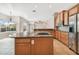 Bright open kitchen features stainless steel appliances, granite countertops, and breakfast bar at 23523 Gracewood Cir, Land O Lakes, FL 34639