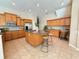 Spacious kitchen with granite counters, wood cabinets, stainless appliances, and a center island at 23523 Gracewood Cir, Land O Lakes, FL 34639