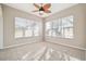 Bright sunroom featuring neutral walls, tile floors and an elegant ceiling fan at 23523 Gracewood Cir, Land O Lakes, FL 34639